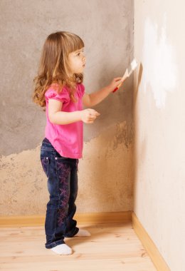 little child with paintbrush on background old wall clipart