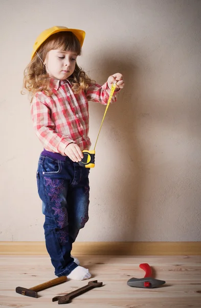 Little girl plays in the builder — Stock Photo, Image