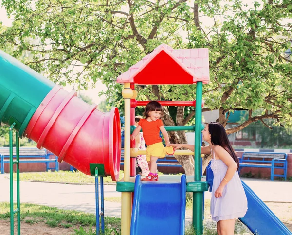 Happy family on playground — Stock Photo, Image