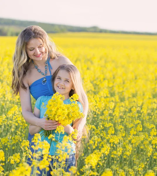 Happy family in spring field — Stock Photo, Image