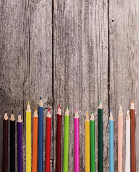 Multicolored pencils on the wooden background — Stock Photo, Image