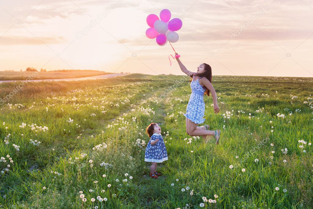baby and mother with balloons outdoor