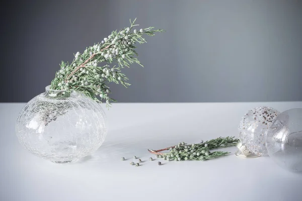 Juniper Branches Glass Vase Christmas Balls Gray Background — Stock Photo, Image