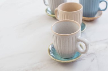 çok renkli seramik bardaklar ve beyaz mermer tabaklar