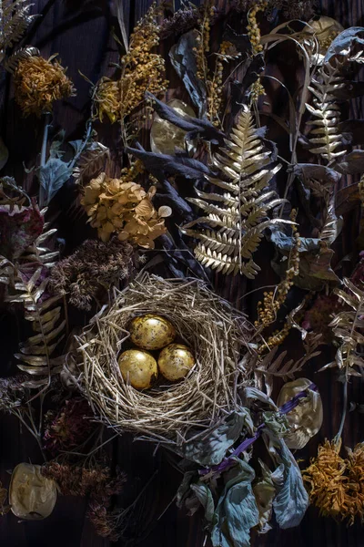 Golden Quail Eggs Nest Dried Flowers Dark Wooden Background — Stock Photo, Image