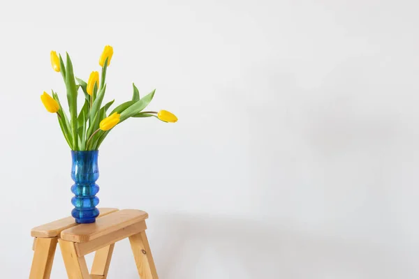 Желтые Тюльпаны Синей Стеклянной Вазе Белом Фоне — стоковое фото
