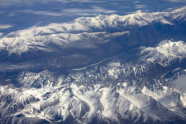 Pattern of snow, clouds and stones — Stock Photo, Image