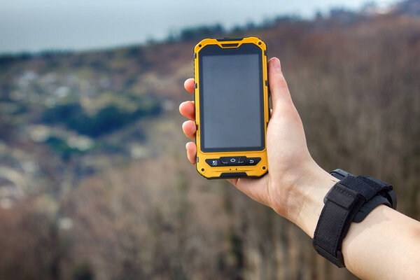 smartphone tracking travel on mountain trails. Phone in hand in a natural walking