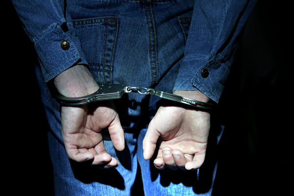 Handcuffs on Hands closeup