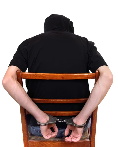 Człowiek w kajdankach na krześle — Zdjęcie stockowe
