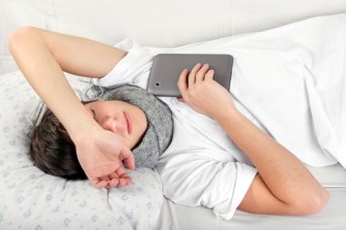 Sick Teenager with Tablet clipart