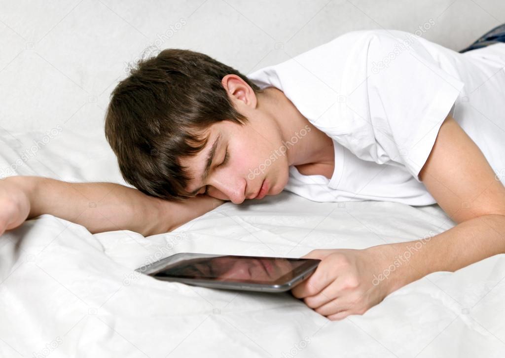 Young Man sleeps with Tablet Computer