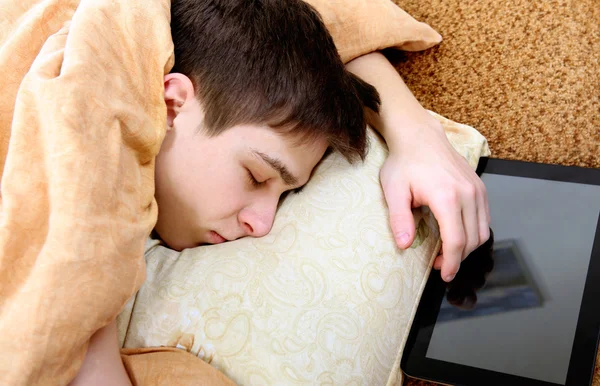 Tablet ile genç uyur — Stok fotoğraf