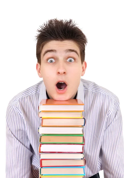 Estudante surpreso com os livros — Fotografia de Stock