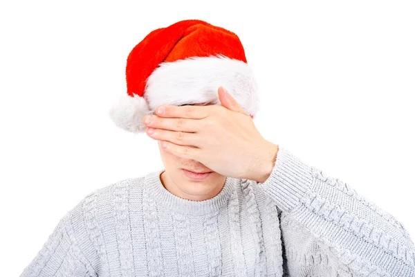 Junger Mann Mit Weihnachtsmütze Bedeckt Die Augen Mit Einer Hand — Stockfoto