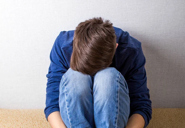 Sad Young Man Couch Wall — Stock Photo, Image