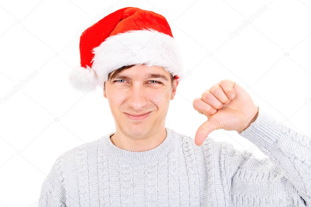 Unhappy Young Man in Santa Hat make Thumb Down on the White Background
