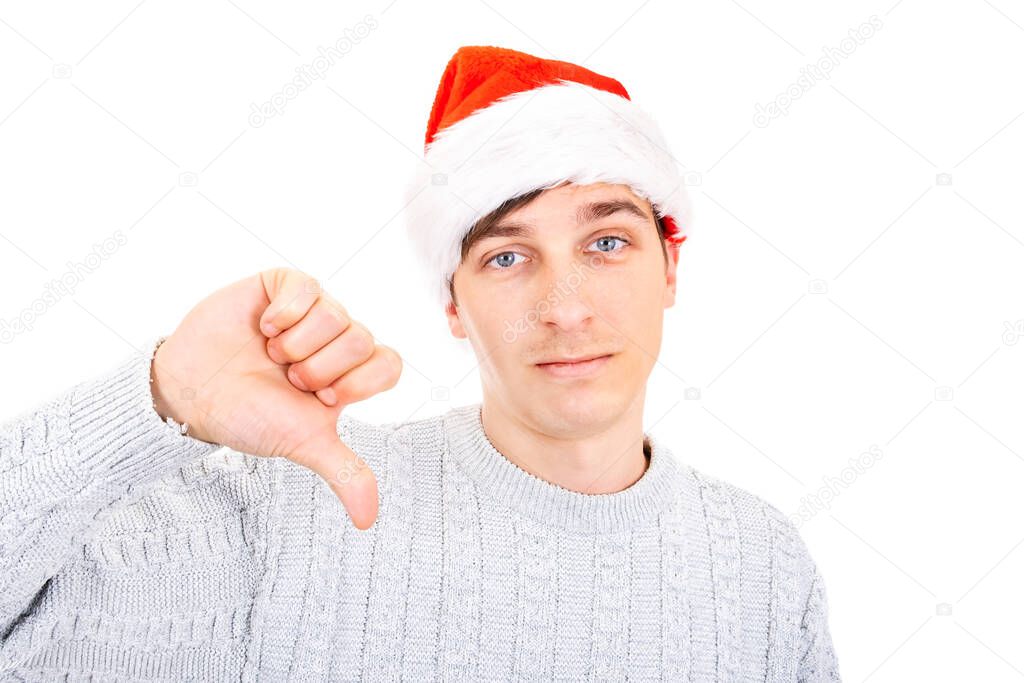 Unhappy Young Man in Santa Hat make Thumb Down on the White Background