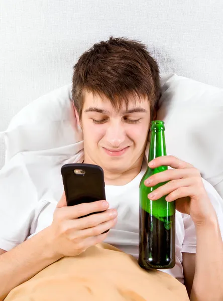 Unhappy Young Man Phone Beer Bottle Bed — Stock Photo, Image