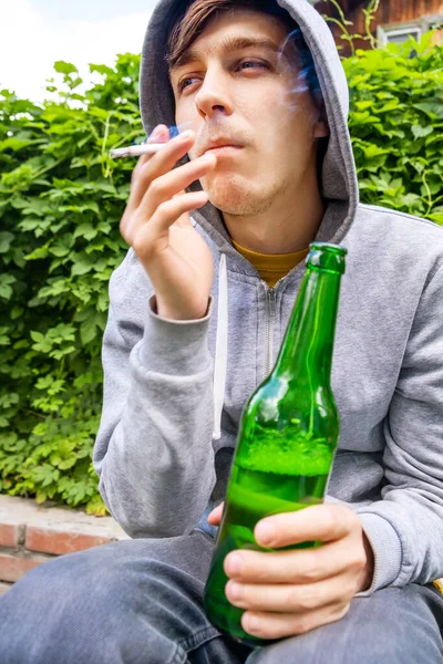 Young Man Drink Beer Smoke Cigarette Green Leaves Background — Stock Photo, Image