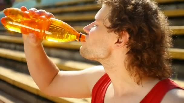 Young man removes thirst after sports — Stock Video