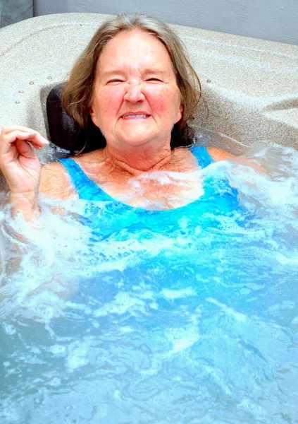 在室外热浴缸里成熟的女性老年人的表情 — 图库照片