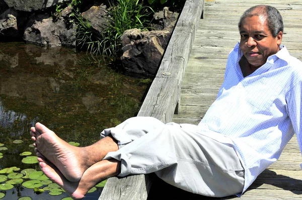 African American Male Senior Sitting Pond — Stockfoto