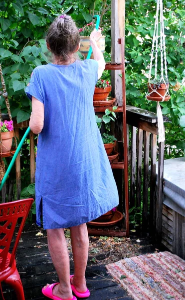 Mature Female Senior Watering Her Flowers Patio Deck — Stock Photo, Image