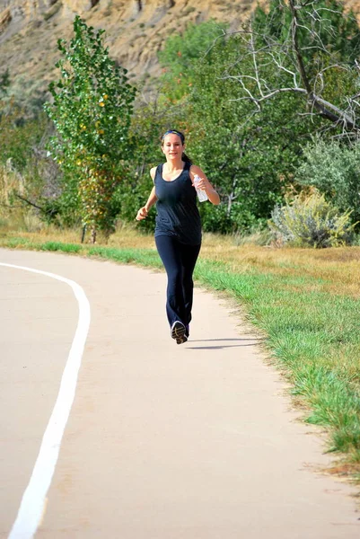 Female beauty on running trail outdoors.