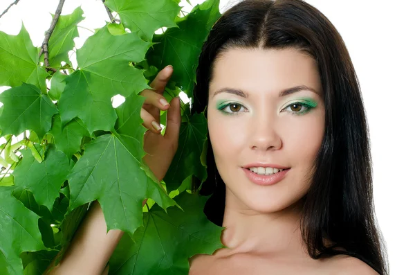 Beautiful woman with spring green leaves — Stock Photo, Image