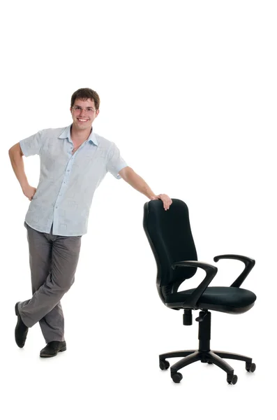 The businessman stands at an armchair — Stock Photo, Image