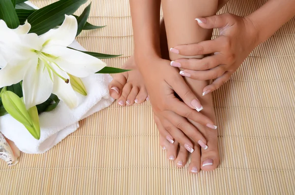 Vrouw hand en voeten met manicure — Stockfoto