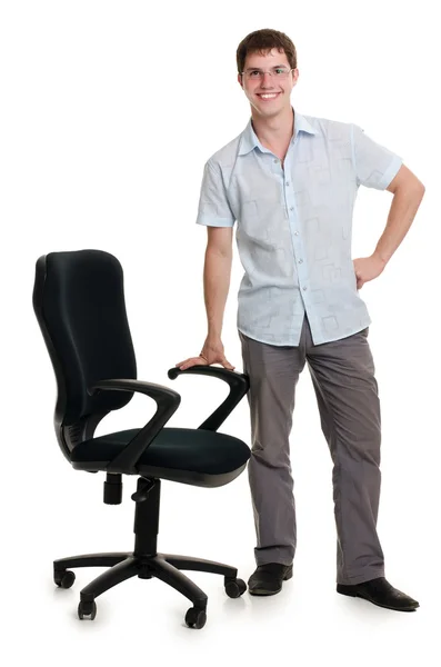 The businessman stands an armchair isolated — Stock Photo, Image