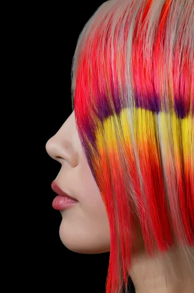 The beautiful girl with a bright make-up and multi-coloured strand in hair