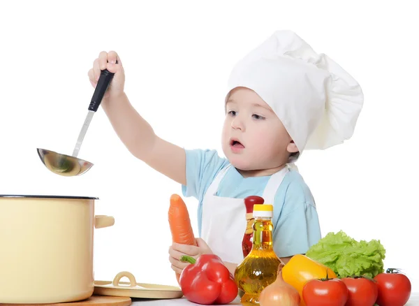 Den lille dreng i en hat af kokken - Stock-foto