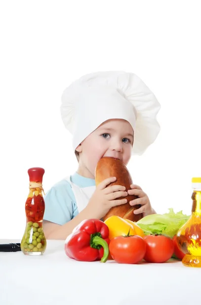 Den lille dreng i en hat af kokken - Stock-foto