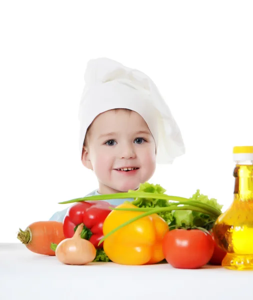 Den lille dreng i en hat af kokken - Stock-foto