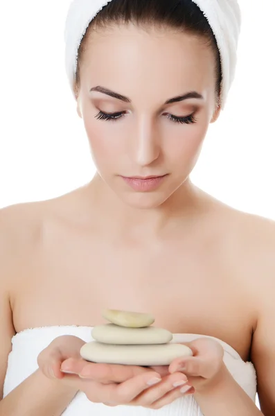 The beautiful woman holds stones in hands. SPA concept. — Stock Photo, Image