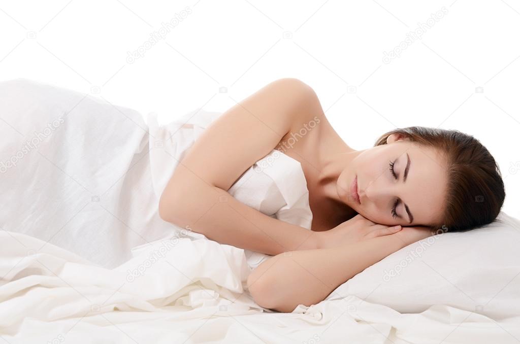 The beautiful woman sleeps in bed