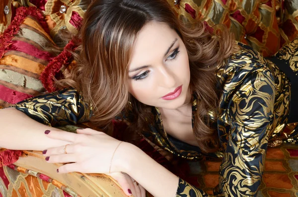 The elegant woman on a magnificent sofa close up — Stock Photo, Image