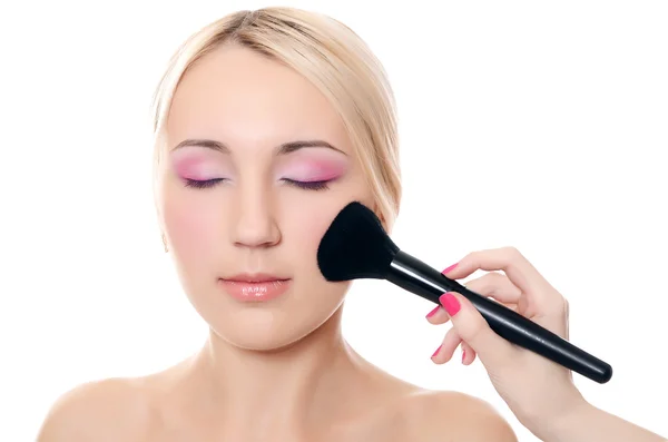 Beautiful girl put the makeup on the face — Stock Photo, Image