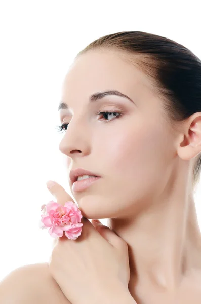 The beautiful woman holds a flower of a carnation at the face — Stock Photo, Image