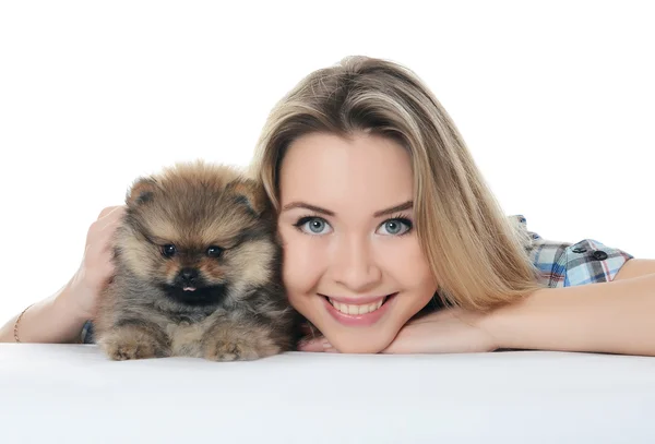 The beautiful girl with a puppy spitz — Stock Photo, Image