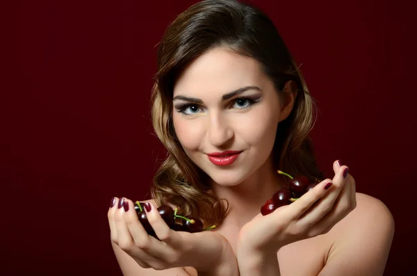 The beautiful woman with sweet cherry — Stock Photo, Image