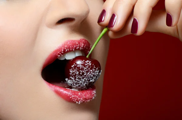 Female lips closeup with sweet cherry — Stock Photo, Image