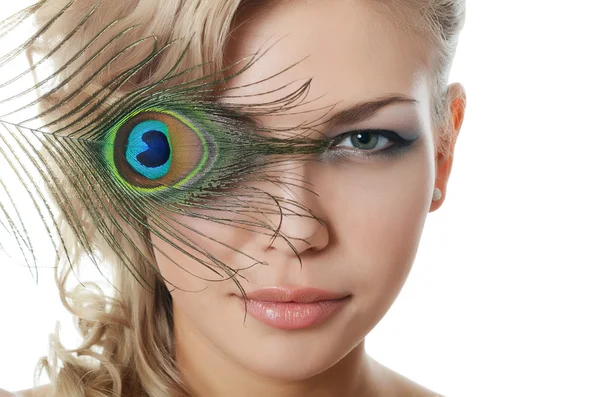 The beautiful woman with feathers of a peacock — Stock Photo, Image