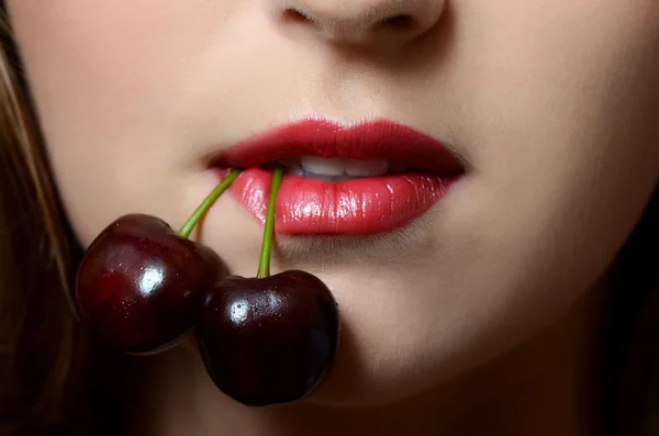 Female lips closeup with sweet cherry — Stock Photo, Image