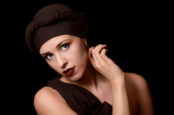 The beautiful woman in a turban with a creative make-up