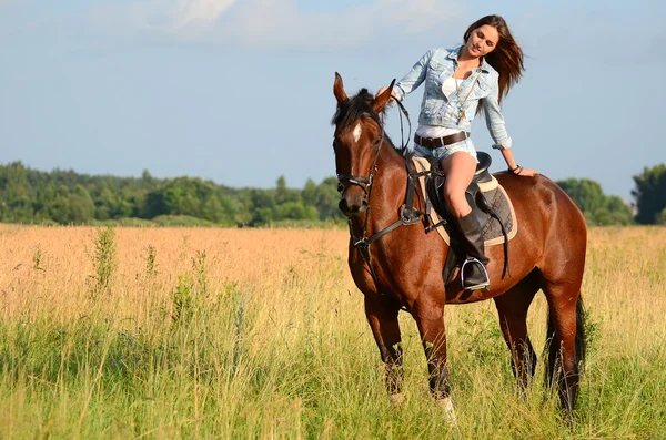 The woman on a horse in the field — Stock Photo, Image