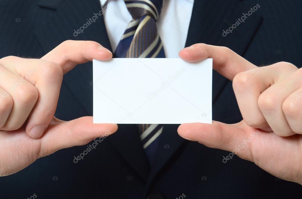 The businessman in a business suit with visiting card